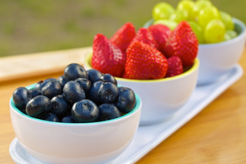 Blueberries, strawberries and grapes in cans