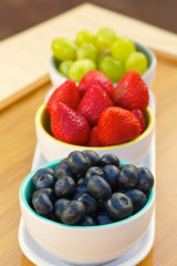 Blueberries, strawberries and grapes in cans