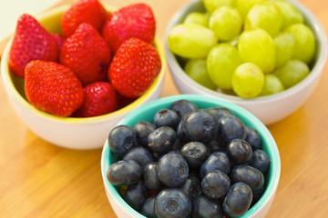 Blueberries, strawberries and grapes in cans