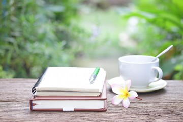 Notebook  and coffee on wooden table