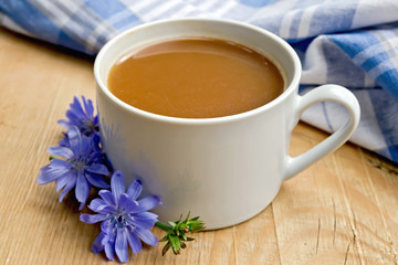 Chicory drink in white cup with flower on board