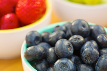 Blueberry and strawberry in white cans