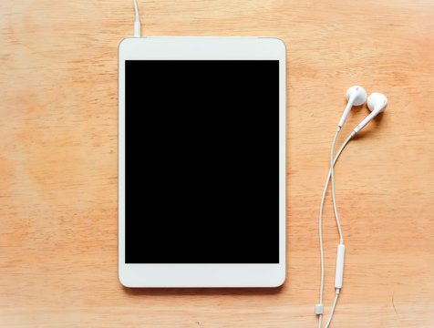 White Digital Tablet On Wooden Table