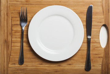 Stainless steel cutlery on wooden board