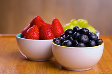 Blueberries, strawberries and grapes in cans