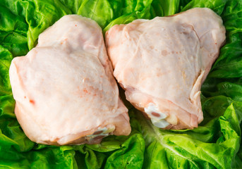 Fresh skinless chicken thighs on salad