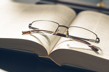 picture a pile of books and eyeglasses, with retro effect