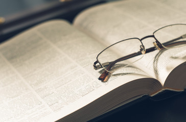 picture a pile of books and eyeglasses, with retro effect