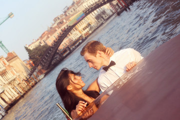 Bride and groom on a boat in Venice, loving each other