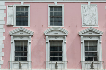 White Windows on Old Pink Government Building in Bahamas