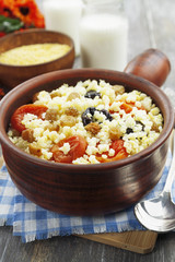 Millet porridge with dried apricots and prunes in a bowl