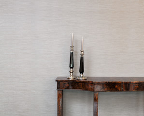 Sideboard in front of a grey wall with luxury candle stick