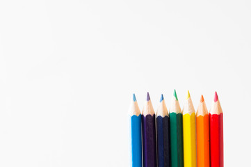 Fototapeta premium Colored pencils lined up in a row in the order of shade