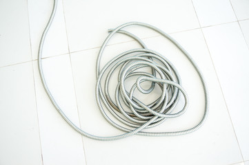 flexible metal hose on floor