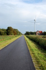 Fototapeta na wymiar Cycle path with house and windmill