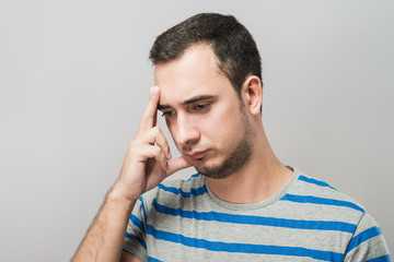 Depressed young man  holding head in hands