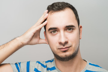 Obraz premium Depressed young man holding head in hands