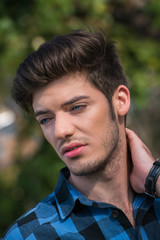 Sexy young man with blue eyes looking away