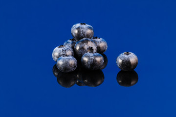 Blueberry on blue surface