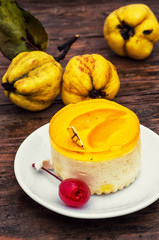round cake covered with quince jam on wooden texture