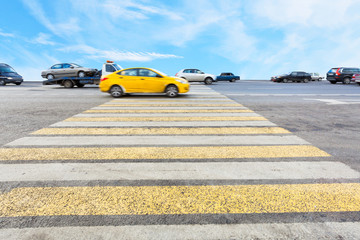 cab at yellow and white crossing zebra