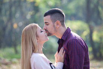 Young couple kissing in autumn park