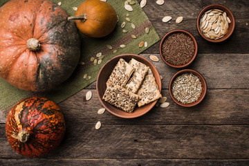 Pumpkins with cookies and seeds on wood in Rustic style.