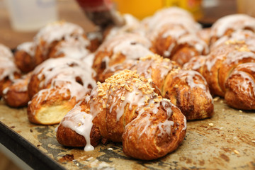 Fresh croissants out of the oven and decorated with icing and wa