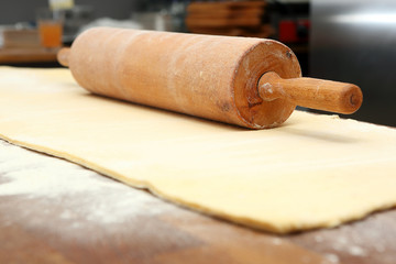 Roller and dough into the kitchen table ready for rolling