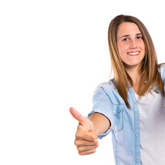 Girl with thumbs up over white background