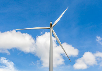 Closeup of wind turbine producing alternative energy in wind far
