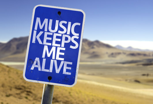 Music Keeps Me Alive sign with a desert background