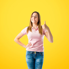 Girl with thumb up over yellow background