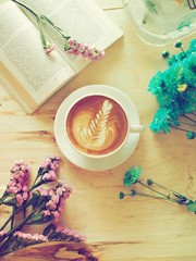 coffee latte art on the wood desk with flower