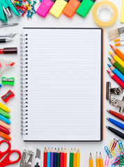 Blank notebook with colourful crayons