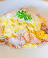 omelet and bacon on white plate.