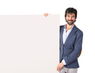 Businessman with empty placard over idolated white background