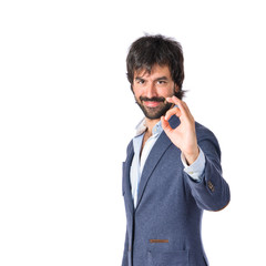 Businessman making Ok sign over white background