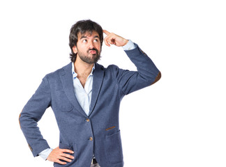 Brunette man thinking over isolated white background