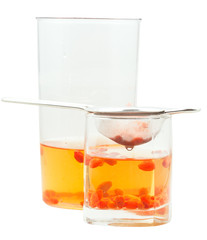 side view of pot and glass goji berries infusion