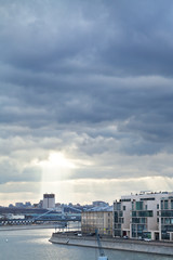 dark rainy clouds and sunbeams over Moscow city