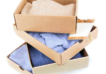 Clothes in open containers with card - 73109177