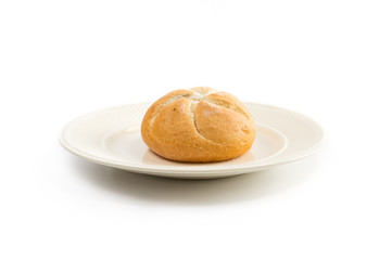 One kaiser roll on an off-white plate