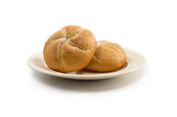 Two kaiser rolls on an off-white plate