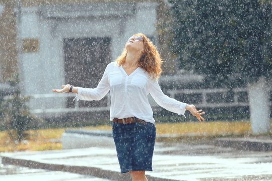 Portrait Of Red-haired Happy Woman In The Rain