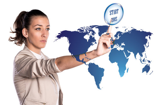Young business woman touching a start button of future 2015