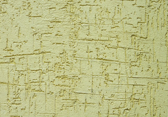 Light green rough plaster on wall closeup