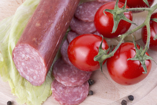 sliced salami with Cherry tomato and seasoned with black pepper