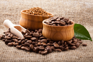 coffee beans in wooden bowl and chocolate on burlap tablecloth