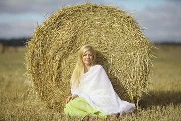 Naklejka na ściany i meble beautiful young blond lying on the grass yellow